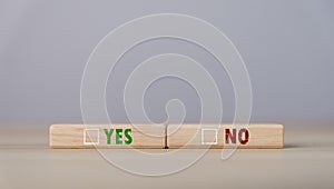 The wooden block shows yes or no letters. The concept of making decisions, voting, and thinking right and wrong. Business options