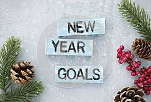 wooden block with text 2022 NEW YEAR GOALS on table background. Resolution, strategy, solution, business and holiday