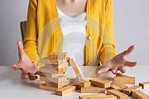 Wooden block and tower collapses, Management of risks and economic instability concept