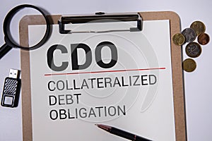 A wooden block with the word CDO Collateralized debt obligation written on it on a white background.