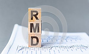 Wooden block with words RMD - acronim RMD - Required Minimum Distributions photo