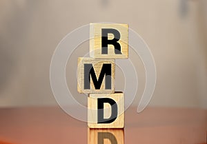 wooden block with words RMD required minimum distributions photo