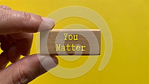 Wooden block with the words You matter. Motivational concept