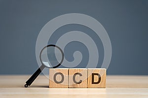 Wooden blocks with the abbreviation OCD. Obsessive compulsive disease. Mental health and psychiatry
