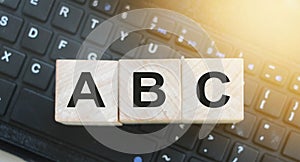 Wooden blocks ABC on computer keyboard. Computer literacy education concept