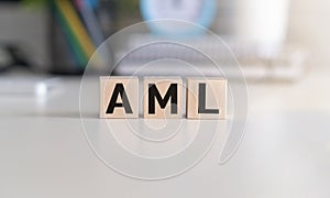 wooden blocks with AML text - Anti-Money Laundering - on white table background. financial, marketing and business concepts