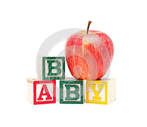 Wooden blocks and apple with baby isolated on white background
