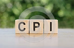 Wooden blocks arranged to spell out the acronym CPI on a table