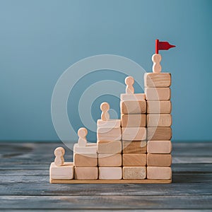 Wooden blocks in ascending order lead to red flagged peak, symbolizing progress and success photo