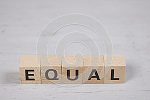 wooden blocks building the word equal