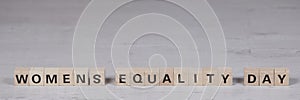 wooden blocks building the word womens equality day