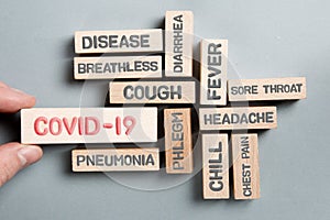 Wooden Blocks with COVID-19 Symptoms