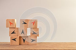 Wooden blocks with different arrow directions. Business innovation, unique and think different concept