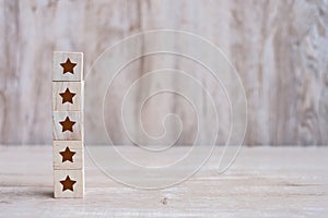 Wooden blocks with the five star symbol. Customer reviews, feedback, rating, ranking and service concept