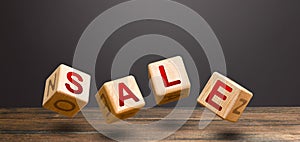 Wooden blocks form word Sale. Sales announcement and high discounts on goods. Shopping event. Promotions attracting customers