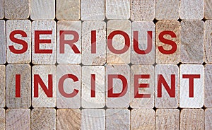 Wooden blocks form the words `serious incident`. Beautiful wooden background