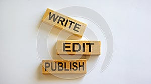 Wooden blocks form the words `write, edit, publish` on white background