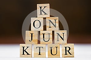 Wooden blocks with german word conjuncture, stumulus package and finance