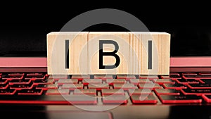 Wooden blocks with IBI text on laptop keyboard, business concept photo