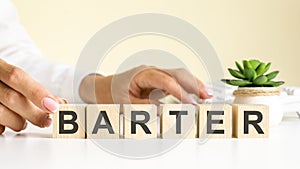 Wooden blocks with letters barter on the office desk, information and communication background