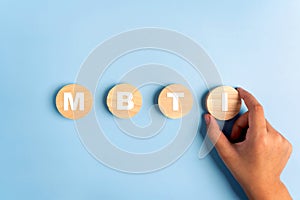 Wooden blocks with the letters MBTI on blue background. Personality typology. Psychology test for human types.MBTI - Myers-Briggs photo