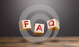 Wooden blocks make word abbreviation FAQ frequently asked questions. Convenient form of answers explanations for users