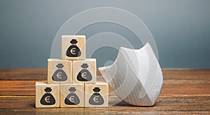 Wooden blocks with money and protection shield. Concept security of money, guaranteed deposits. Client rights protection. photo