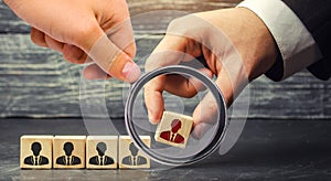 Wooden blocks with a picture of workers. the businessman or CEO removes / dismisses the employee. management within the team. photo