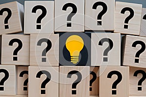 Wooden Blocks with Question Marks and Light Bulb - Symbol of Problem Solving and Ideas