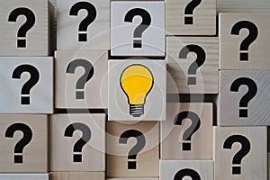Wooden Blocks with Question Marks and Light Bulb - Symbol of Problem Solving and Ideas