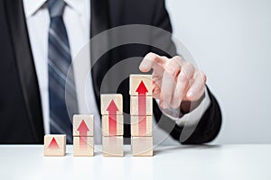 Wooden blocks with red arrows icons, business profit success concept