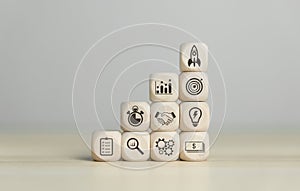 Wooden blocks showing a rocket icon Startup business concept Entrepreneurship and online digital business network connection on