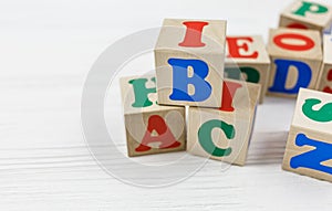 Wooden blocks spell out ABC on the wooden table. Games and tools for kids in preschool or daycare. Education, back to school