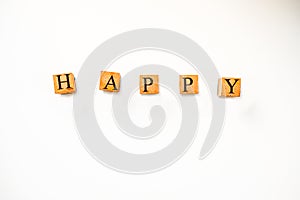 Wooden Blocks Spell Out Happy on White Background