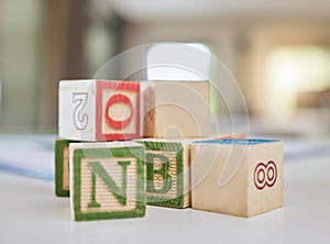 Wooden blocks, table and letters for learning, education or childhood development at home. Colorful wood cube toys to