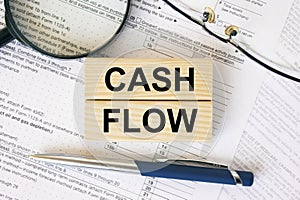 Wooden blocks with text Cash Flow on financial docs