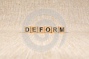Wooden blocks with the text: deform, concept