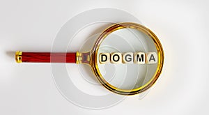 Wooden Blocks with the text: DOGMA on a magnifying glass photo