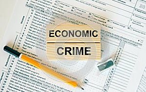 Wooden blocks with text Economic Crime on financial docs