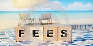 Wooden Blocks with the text: Fees. Taxes business concept