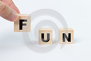 Wooden blocks with text FUN isolated on a white background.W