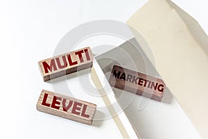 Wooden blocks with text MLM in a box on a white background
