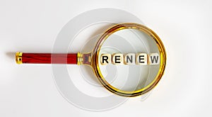 Wooden Blocks with the text: RENEW on a magnifying glass