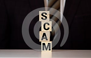 Wooden Blocks with the text: Scam