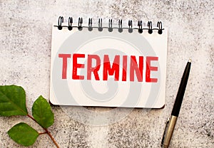 Wooden blocks with the text: TERMINE. The text is written in red letters photo