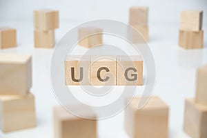 Wooden blocks on a white background with the inscription - ucg