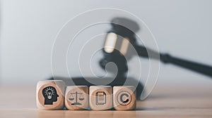 wooden blocks and Wooden judge gavel on the table, concept of copyright or intellectual property patent protection of copyright