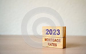 Wooden blocks with the word 2023 mortgage rates. Loan and credit interest. Apartments, housing, house. Real estate market analysis