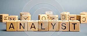 Wooden blocks with the word Analyst. Analytical reasoning and research. Forecasting processes and developing promising development