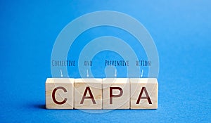 Wooden blocks with the word CAPA. Corrective and Preventive action plans. Business management concept. Strategy and efficiency.